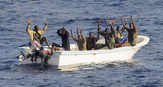 Suspected pirates keep their hands in the air as directed by sailors aboard the guided-missile cruiser USS Vella Gulf (CG 72) (not shown), in the Gulf of Aden, February 11, 2009. A multinational naval force seized the seven suspected pirates in the first such action in its anti-piracy campaign, the U.S. Navy said. ©  SW